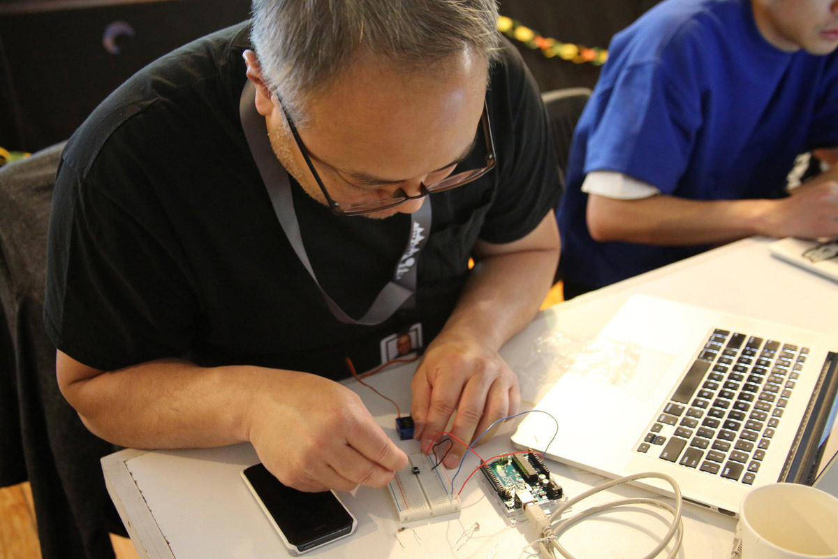 A man connecting his Arduino to a circuitboard